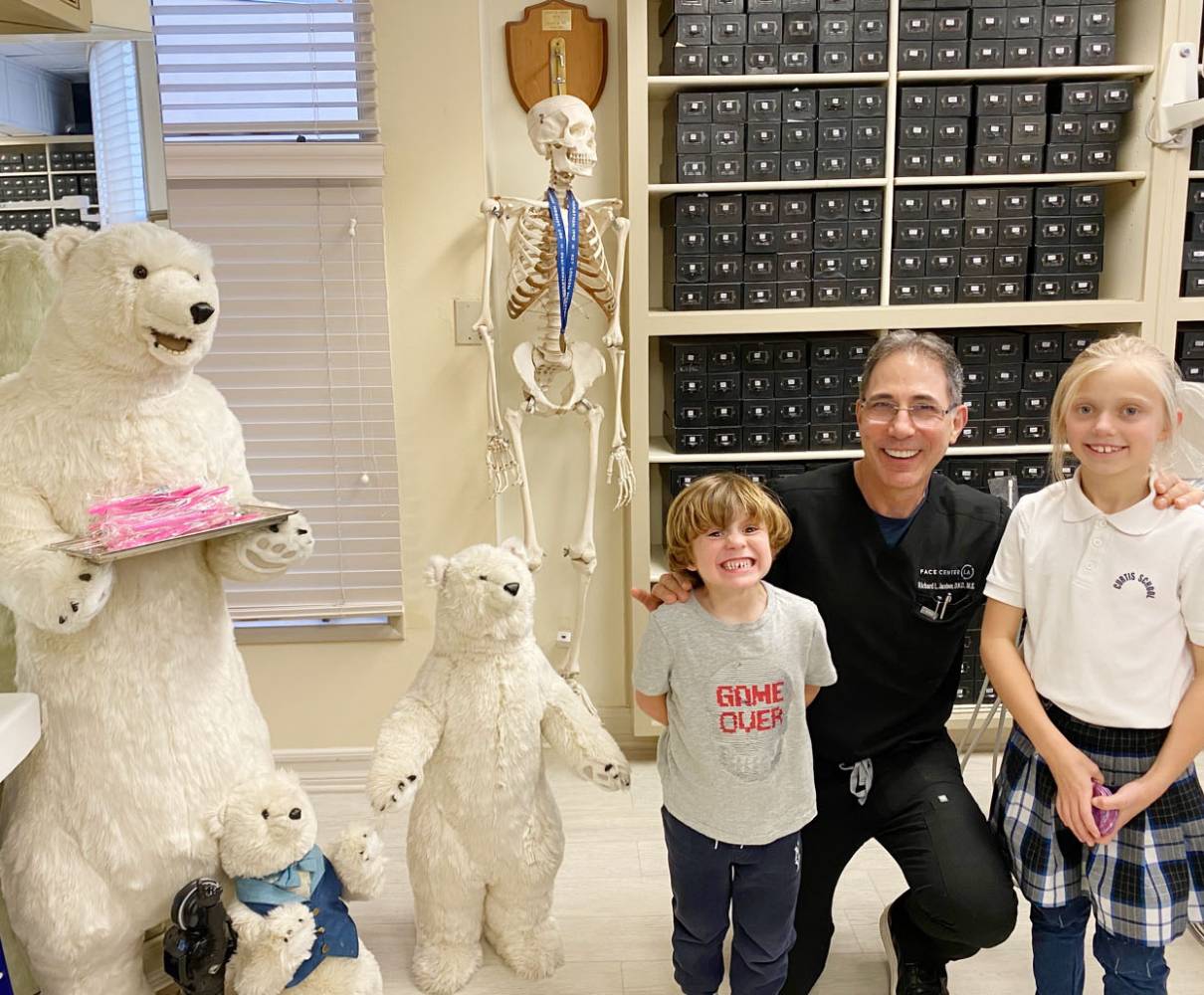 Dr Jacobson with smiling children patients